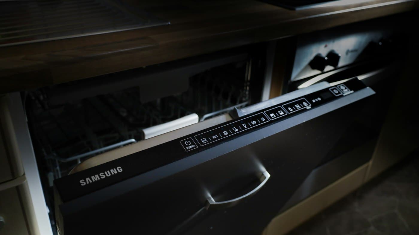 Built-in dishwasher with its door partly open