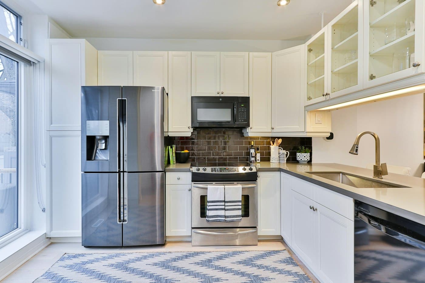 Stainless steel french door refrigerator in a white kitchen
